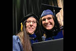 Selfie of Brittney and Mary on stage at the Doctoral Hooding Ceremony.